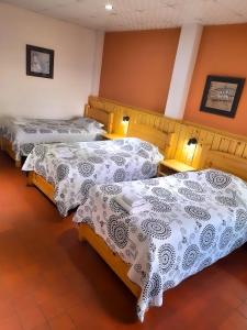 A bed or beds in a room at Cittadella Hostal