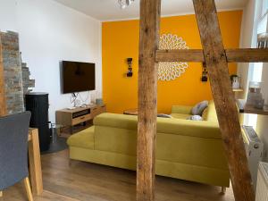 a living room with a couch and a tv at Stadthaus Artur - Apartment Valencia in Remscheid