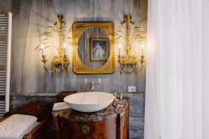 a bathroom with a sink and a mirror at Castello Di Casalborgone in Casalborgone
