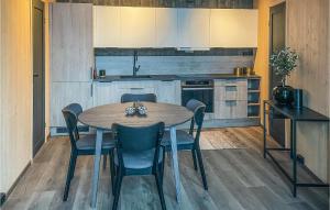 a kitchen with a table and chairs in a kitchen at Awesome Home In Grua With House A Panoramic View in Harestua