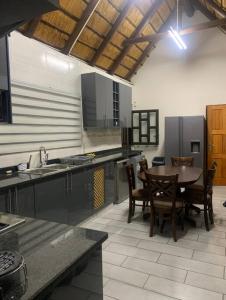 a large kitchen with a table and chairs in it at Kruger Nest in Marloth Park