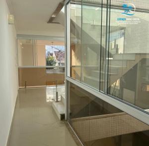 ein leeres Zimmer mit einem Glasfenster in einem Gebäude in der Unterkunft Espaço Rose Costa in Niterói