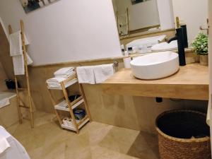 a bathroom with a sink and a mirror at Apartamentos Serrallo in Granada