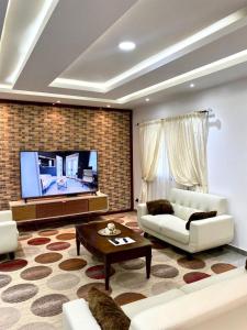 a living room with a couch and a tv at luxury suites CHESTER ONE in Dakar