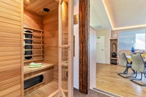 a room with a sauna with two chairs and a table at Azuria Schwarzwald Loft in Kappelrodeck