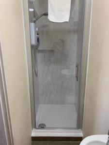 a shower in a bathroom with a person taking a picture at Parkview Guesthouse in Cambridge