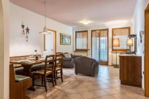 a kitchen and living room with a table and chairs at Villa Lory 2 in Canazei