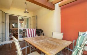 a dining room with a wooden table and chairs at Gorgeous Apartment In Sanlcar De Barrameda With Wifi in Sanlúcar de Barrameda