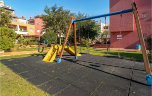 a playground in a park with a yellow slide at Gorgeous Apartment In Sanlcar De Barrameda With Wifi in Sanlúcar de Barrameda