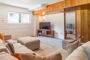 a living room with a couch and a flat screen tv at The Redwood Sanctuary in Monte Rio