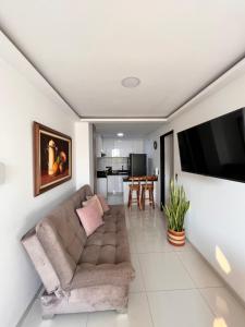 a living room with a couch and a flat screen tv at Apartamento en Cartago in Cartago