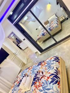 a view of a bedroom with a bed and a mirror at luxury suites CHESTER ONE in Dakar