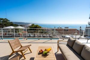 a living room with a couch and a table at Panoramic Views - Terrace, Sea Views & Pool in Nazaré