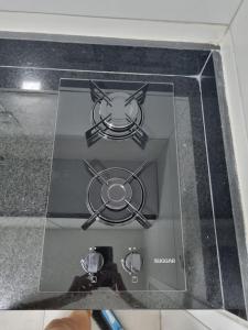 a glass box with a picture of a stove at Excelente Flat beira-mar in Cabedelo