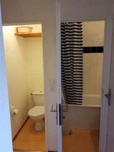 a bathroom with a white toilet and a shower at BORSAT 4 in Tignes