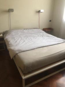 a bed in a bedroom with a white bedsheet at Casa Paslawski in Corciano