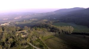 an aerial view of a field with trees and mountains at Appartamento immerso nella natura, silenzio e riservatezza a 550 m di quota in Langhirano