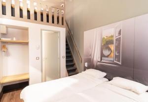 Postel nebo postele na pokoji v ubytování B&B HOTEL Limoges 2