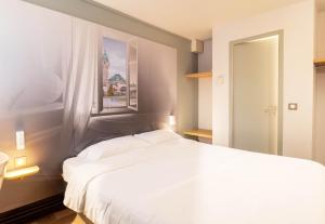 Postel nebo postele na pokoji v ubytování B&B HOTEL Limoges 2