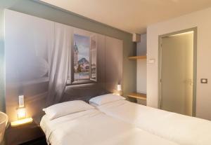 Postel nebo postele na pokoji v ubytování B&B HOTEL Limoges 2