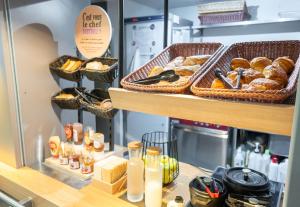 a bakery with breads and pastries on a shelf at B&B HOTEL Limoges 2 in Limoges