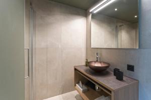 a bathroom with a bowl sink and a shower at Hotel Romantica in Samnaun +43 photos