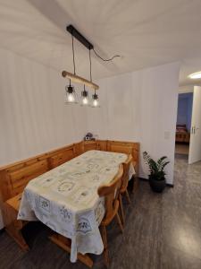 a dining room with a table and some lights at Haus Rizzi in Bivio