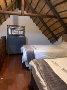 a bedroom with two beds and a window at Kruger Nest in Marloth Park