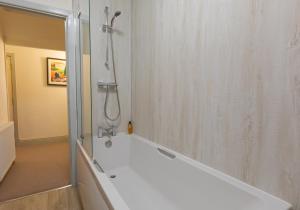 Das Bad ist mit einer Dusche und einer Badewanne ausgestattet. in der Unterkunft Stonyhurst Spacious apartment, great location. in Clitheroe