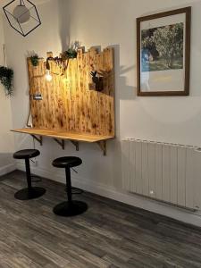 a room with two stools and a picture on the wall at Le Cosy'ppart - EasyLife in Bourgoin