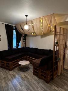 a living room with a couch and a bed at Le Cosy'ppart - EasyLife in Bourgoin