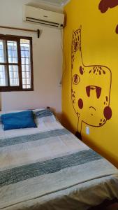 a bedroom with a bed with a cat painted on the wall at Santa Margherita in José Ignacio