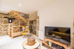 a living room with a large flat screen tv at Manoir de Kervegan : Le Logis du P’tit Levant in Lannion