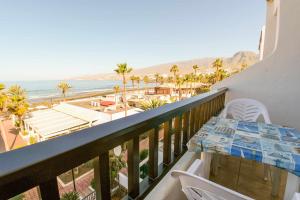 balcón con mesa y vistas a la playa en Parque Santiago II 379 Tenerife Rental and Sales, en Playa de las Américas