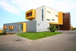 a house with a green lawn in front of it at Esperia Palace Hotel & Resort Spa in Zafferana Etnea