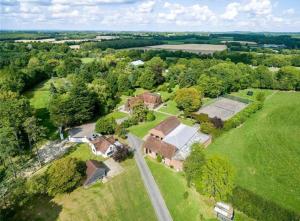 an aerial view of a house in a field at The White Cottage at Gildridge + Private Hot Tub+EV in Chiddingly