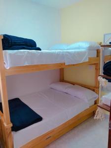 a couple of bunk beds in a room at habitacion privada en Jardin cerca al parque in Jardin