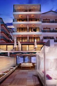 an apartment building with a balcony with a bed at Nur Beach Hotel in Kas