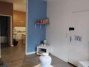 a white vase sitting on a table in a room at Le Grèbe in Le Tréport