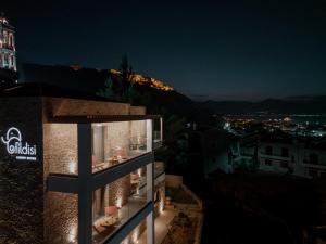 a building with a cross on the side of it at night at Fildisi luxury suites in Nafplio