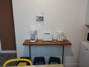 a kitchen with a table with two appliances on it at Le Grèbe in Le Tréport