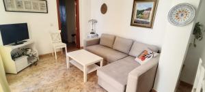 a living room with a couch and a tv at Casa Carmen in Faraján