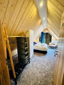 a attic room with a bed and a bunk bed at Maryna Bór in Zakopane