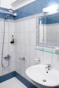 a bathroom with a sink and a shower at Konstantinos Hotel & Apartments I in Nydri