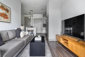 a living room with a couch and a flat screen tv at Downtown 1br w deck gym nr Congress Ave ATX-216 in Austin