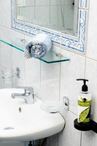 a bathroom with a sink and a mirror at Konstantinos Hotel & Apartments I in Nydri