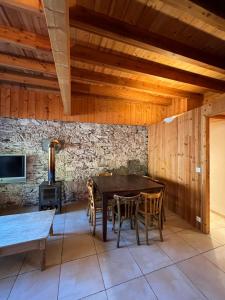 a dining room with a wooden table and chairs at Apartment Les Rousses 3 minutes from Alpe dHuez Grand Domaine via Oz en Oisans in Oz