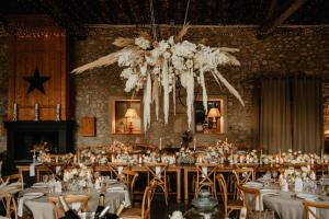a dining room with tables and a chandelier at Mas d'Arvieux in Tarascon