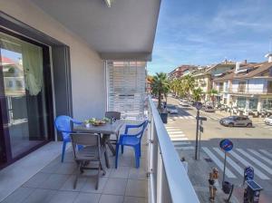 un balcone con tavolo, sedie e una strada di Trilocale Laureati vista mare a 50m dalla spiaggia a San Benedetto del Tronto