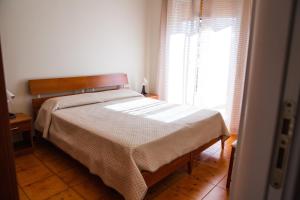 a bedroom with a bed and a window at B&B Ulisse in Ispica +7 photos